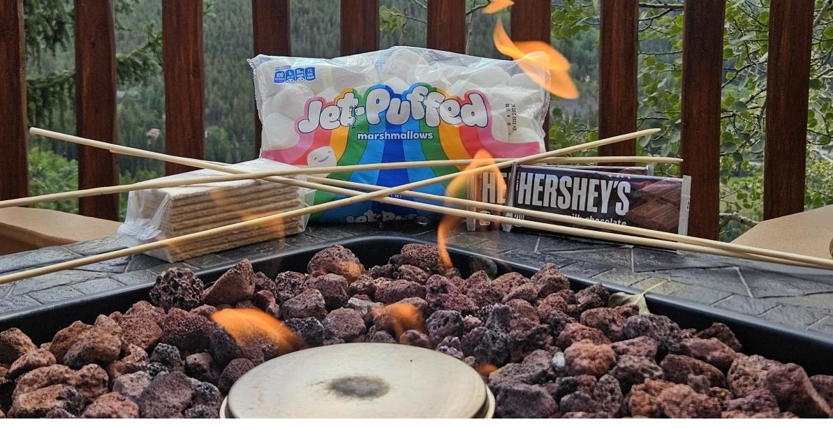 Roasting a s’moreover an outdoor fire at a hotel in Breckenridge.